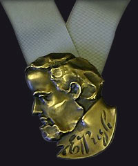 The Evan Pugh Medal, a bronze sculpted award on a ribbon. 