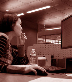 A woman using a computer.
